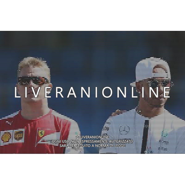 (L to R): Kimi Raikkonen (FIN) Ferrari and Lewis Hamilton (GBR) Mercedes AMG F1 on the drivers parade observe a minute\'s silence for Justin Wilson. 06.09.2015. Formula 1 World Championship, Rd 12, Italian Grand Prix, Monza, Italy, Race Day. AG ALDO LIVERANI SAS ONLY ITALY
