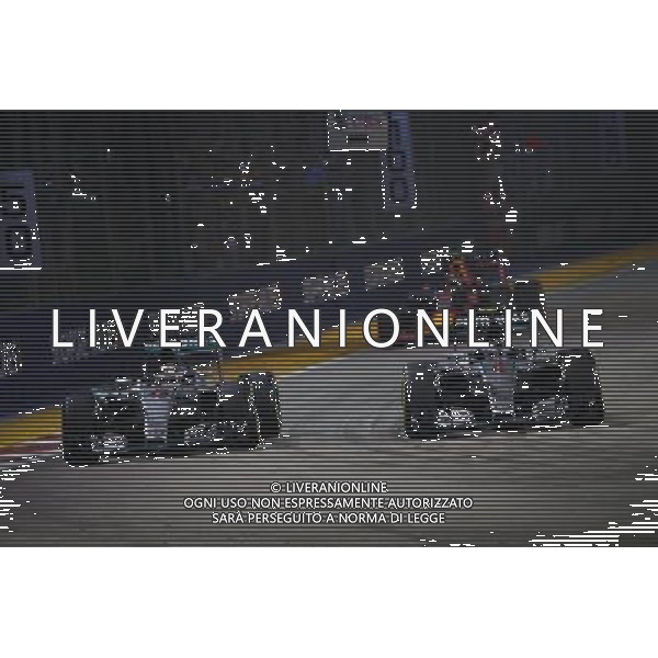 Nico Rosberg (GER) Mercedes AMG F1 W06 passes team mate Lewis Hamilton (GBR) Mercedes AMG F1 W06. 20.09.2015. Formula 1 World Championship, Rd 13, Singapore Grand Prix, Singapore, Singapore, Race Day. AG ALDO LIVERANI SAS ONLY ITALY