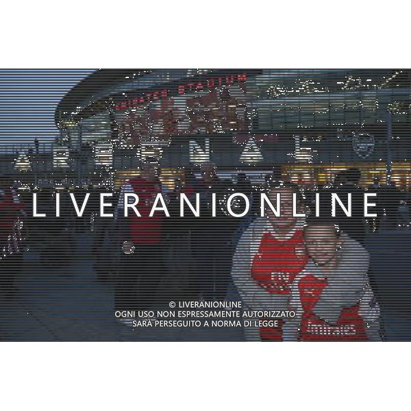 Young fans pose for a photo outside The Emirates Stadium, home of Arsenal Photographer Craig Mercer/CameraSport Football - UEFA Champions League Group F - Arsenal v Olympiakos - Tuesday 29th September 2015 - Emirates Stadium - London - © CameraSport - 43 Linden Ave. Countesthorpe. Leicester. England. LE8 5PG - Tel: +44 (0) 116 277 4147 - admin@camerasport.com - www.camerasport.com AG ALDO LIVERANI SAS ONLY ITALY