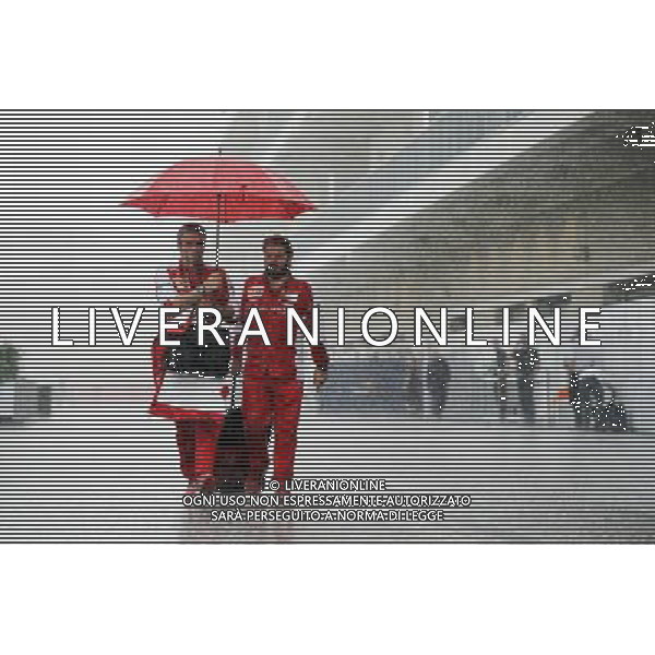 (L to R): Maurizio Arrivabene (ITA) Ferrari Team Principal with Gino Rosato (CDN) Ferrari in a wet and rainy paddock. 23.10.2015. Formula 1 World Championship, Rd 16, United States Grand Prix, Austin, Texas, USA, Practice Day. AG ALDO LIVERANI SAS ONLY ITALY