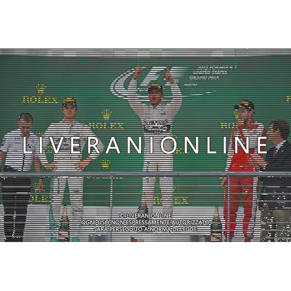 The podium (L to R): Nico Rosberg (GER) Mercedes AMG F1, second; Lewis Hamilton (GBR) Mercedes AMG F1, race winner and World Champion; Sebastian Vettel (GER) Ferrari, third. 25.10.2015. Formula 1 World Championship, Rd 16, United States Grand Prix, Austin, Texas, USA, Race Day. AG ALDO LIVERANI SAS ONLY ITALY