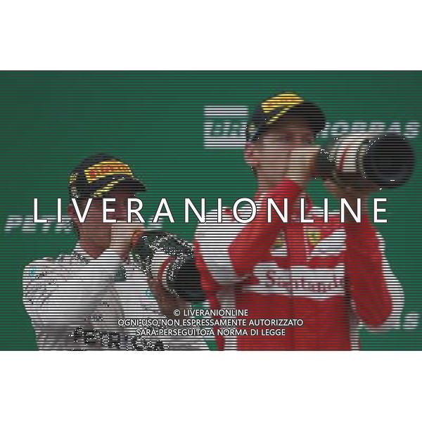 1st place Nico Rosberg (GER) Mercedes AMG F1 W06 with 3rd place Sebastian Vettel (GER) Ferrari SF15-T. 15.11.2015. Formula 1 World Championship, Rd 18, Brazilian Grand Prix, Sao Paulo, Brazil, Race Day. AG ALDO LIVERANI SAS ONLY ITALY