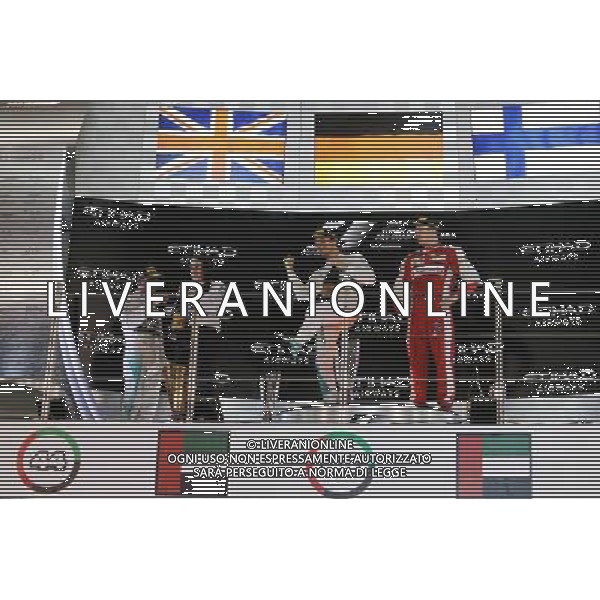 (L to R): Lewis Hamilton (GBR) Mercedes AMG F1 and race winner Nico Rosberg (GER) Mercedes AMG F1 celebrate on the podium with Kimi Raikkonen (FIN) Ferrari. 29.11.2015. Formula 1 World Championship, Rd 19, Abu Dhabi Grand Prix, Yas Marina Circuit, Abu Dhabi, Race Day. AG ALDO LIVERANI SAS ONLY ITALY