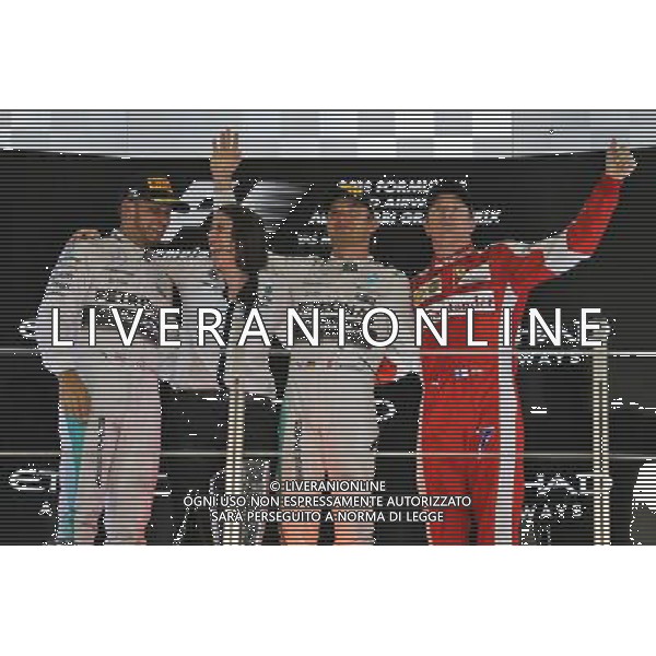 The podium (L to R): Lewis Hamilton (GBR) Mercedes AMG F1, second; Nico Rosberg (GER) Mercedes AMG F1, race winner; Kimi Raikkonen (FIN) Ferrari, third. 29.11.2015. Formula 1 World Championship, Rd 19, Abu Dhabi Grand Prix, Yas Marina Circuit, Abu Dhabi, Race Day. AG ALDO LIVERANI SAS ONLY ITALY