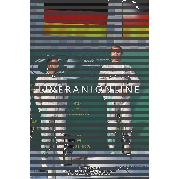 (L to R): Second placed Lewis Hamilton (GBR) Mercedes AMG F1 on the podium with team mate and race winner Nico Rosberg (GER) Mercedes AMG F1. 20.03.2016. Formula 1 World Championship, Rd 1, Australian Grand Prix, Albert Park, Melbourne, Australia, Race Day. / AGENZIA ALDO LIVERANI SAS - ITALY ONLY EDITORIAL USE ONLY