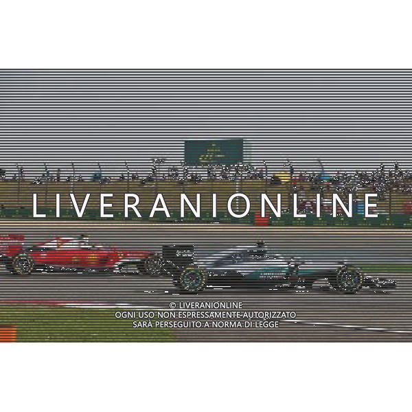 Lewis Hamilton (GBR) Mercedes AMG F1 W07 Hybrid and Kimi Raikkonen (FIN) Ferrari SF16-H battle for position. 17.04.2016. Formula 1 World Championship, Rd 3, Chinese Grand Prix, Shanghai, China, Race Day. AG ALDO LIVERANI SAS ONLY ITALY