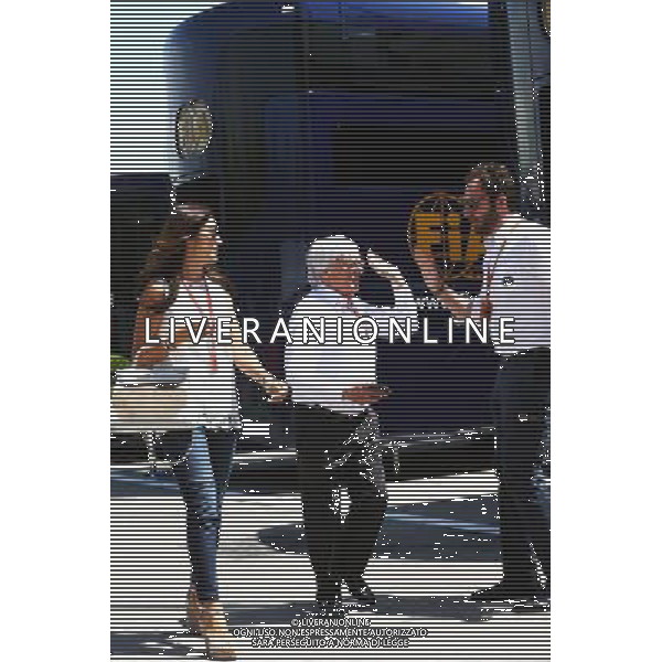 Bernie Ecclestone (GBR) with his wife Fabiana Flosi (BRA), passing Matteo Bonciani (ITA) FIA Media Delegate. 14.05.2016. Formula 1 World Championship, Rd 5, Spanish Grand Prix, Barcelona, Spain, Qualifying Day. AG ALDO LIVERANI SAS ONLY ITALY