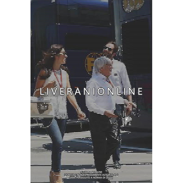 Bernie Ecclestone (GBR) with his wife Fabiana Flosi (BRA), passing Matteo Bonciani (ITA) FIA Media Delegate. 14.05.2016. Formula 1 World Championship, Rd 5, Spanish Grand Prix, Barcelona, Spain, Qualifying Day. AG ALDO LIVERANI SAS ONLY ITALY