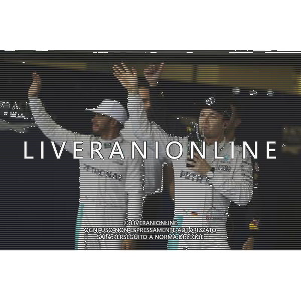Nico Rosberg (GER) Mercedes AMG F1 celebrates his second position in qualifying parc ferme with team mate Lewis Hamilton (GBR) Mercedes AMG F1. 26.11.2016. Formula 1 World Championship, Rd 21, Abu Dhabi Grand Prix, Yas Marina Circuit, Abu Dhabi, Qualifying Day. AG ALDO LIVERANI SAS ONLY ITALY
