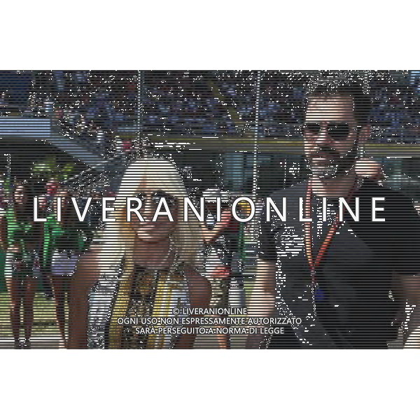 (L to R): Donatella Versace (ITA) Versace Vice President with Marc Hynes (GBR) on the grid. 03.09.2017. Formula 1 World Championship, Rd 13, Italian Grand Prix, Monza, Italy, Race Day. AG ALDO LIVERANI SAS ONLY ITALY