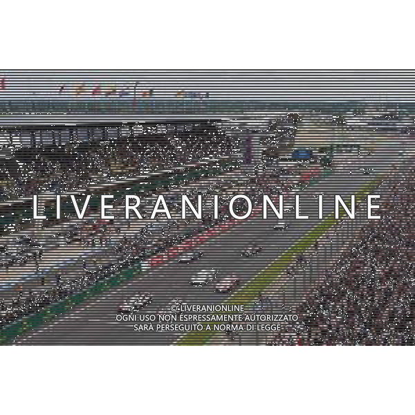 Race winners Sebastien Buemi (SUI) / Kazuki Nakajima (JPN) / Fernando Alonso (ESP) #08 Toyota Gazoo Racing Toyota TS050 Hybrid take the chequered flag at the end of the race alongside second placed Mike Conway (GBR) / Kamui Kobayashi (JPN) / Jose Maria Lopez (ARG) #07 Toyota Gazoo Racing Toyota TS050 Hybrid. AG ALDO LIVERANI SAS-ONLY ITALY