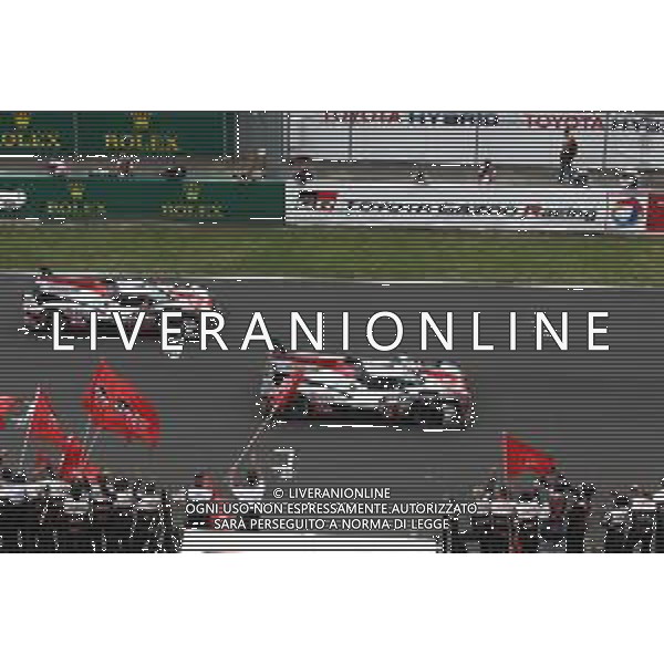 Race winners Sebastien Buemi (SUI) / Kazuki Nakajima (JPN) / Fernando Alonso (ESP) #08 Toyota Gazoo Racing Toyota TS050 Hybrid take the chequered flag at the end of the race alongside second placed Mike Conway (GBR) / Kamui Kobayashi (JPN) / Jose Maria Lopez (ARG) #07 Toyota Gazoo Racing Toyota TS050 Hybrid. AG ALDO LIVERANI SAS-ONLY ITALY
