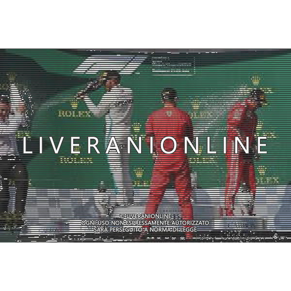 (L to R): Race winner Lewis Hamilton (GBR) Mercedes AMG F1 celebrates with the champagne on the podium with second placed Sebastian Vettel (GER) Ferrari and third placed Kimi Raikkonen (FIN) Ferrari. 29.07.2018. Formula 1 World Championship, Rd 12, Hungarian Grand Prix, Budapest, Hungary, Race Day. /AGENZIA ALDO LIVERANI SAS - ITALY ONLY - EDITORIAL USE ONLY - F1 GP UNGHERIA GARA 29.07.2018