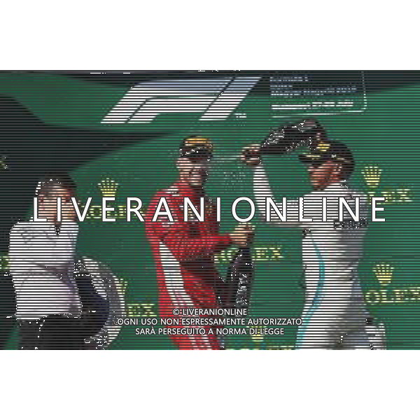 (L to R): Sebastian Vettel (GER) Ferrari celebrates with the champagne his second position on the podium with race winner Lewis Hamilton (GBR) Mercedes AMG F1. 29.07.2018. Formula 1 World Championship, Rd 12, Hungarian Grand Prix, Budapest, Hungary, Race Day. /AGENZIA ALDO LIVERANI SAS - ITALY ONLY - EDITORIAL USE ONLY - F1 GP UNGHERIA GARA 29.07.2018