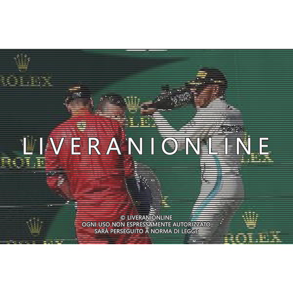 (L to R): Sebastian Vettel (GER) Ferrari celebrates with the champagne his second position on the podium with race winner Lewis Hamilton (GBR) Mercedes AMG F1. 29.07.2018. Formula 1 World Championship, Rd 12, Hungarian Grand Prix, Budapest, Hungary, Race Day. /AGENZIA ALDO LIVERANI SAS - ITALY ONLY - EDITORIAL USE ONLY - F1 GP UNGHERIA GARA 29.07.2018