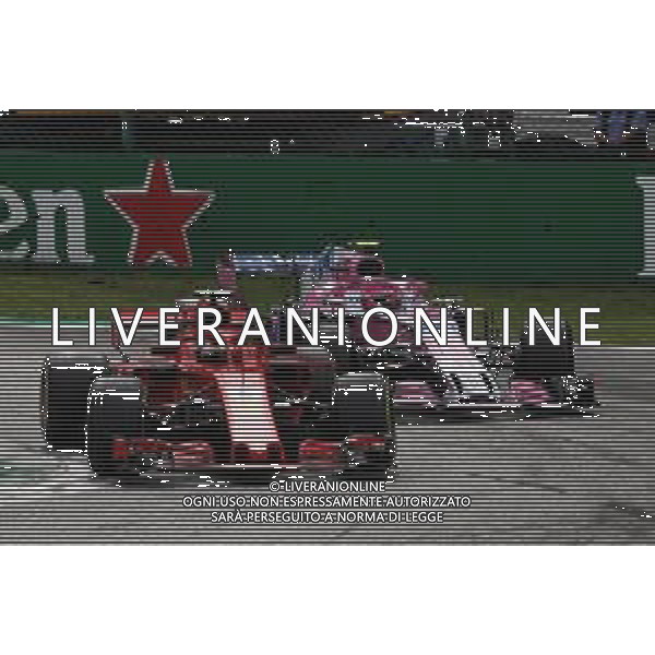 Sebastian Vettel (GER) Ferrari SF71H and Esteban Ocon (FRA) Racing Point Force India F1 VJM11 battle for position. 02.09.2018. Formula 1 World Championship, Rd 14, Italian Grand Prix, Monza, Italy, Race Day. AG ALDO LIVERANI SAS-ONLY ITALY