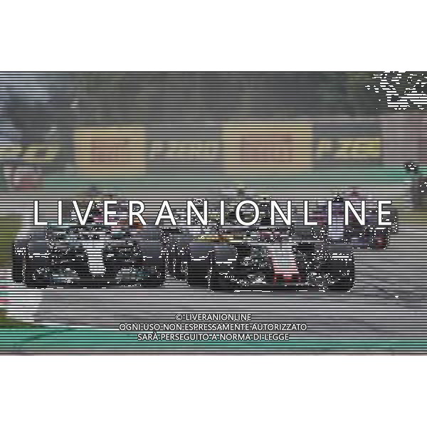 Romain Grosjean (FRA) Haas F1 Team VF-18 and Valtteri Bottas (FIN) Mercedes AMG F1 W09 at the start of the race. 02.09.2018. Formula 1 World Championship, Rd 14, Italian Grand Prix, Monza, Italy, Race Day. AG ALDO LIVERANI SAS-ONLY ITALY