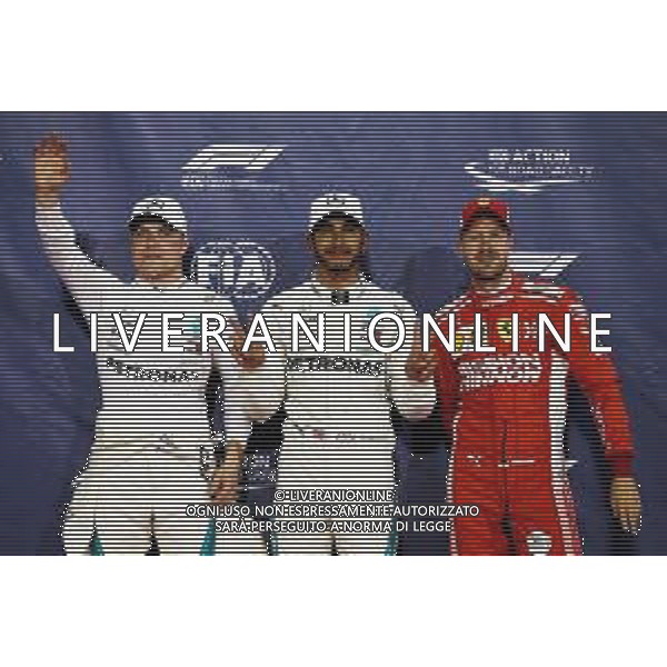 Qualifying top three in parc ferme (L to R): Valtteri Bottas (FIN) Mercedes AMG F1, second; Lewis Hamilton (GBR) Mercedes AMG F1, pole position; Sebastian Vettel (GER) Ferrari, third. 24.11.2018. Formula 1 World Championship, Rd 21, Abu Dhabi Grand Prix, Yas Marina Circuit, Abu Dhabi, Qualifying Day. AG ALDO LIVERANI SAS-ONLY ITALY