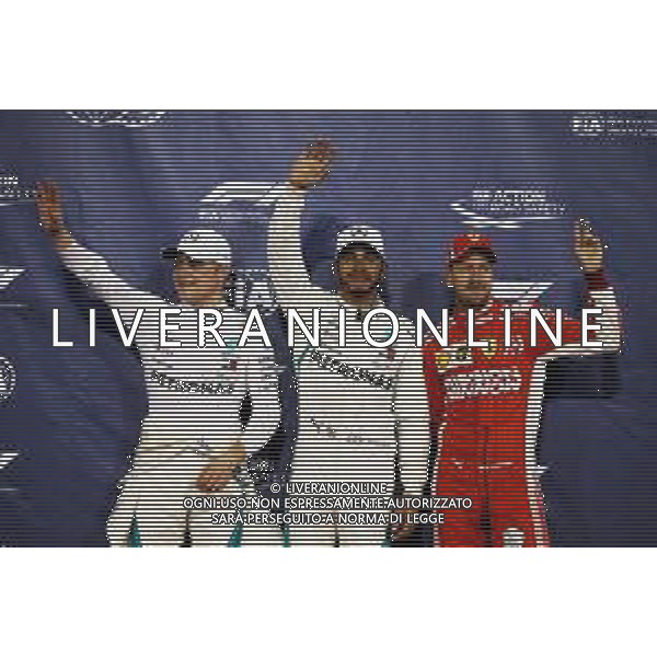 Qualifying top three in parc ferme (L to R): Valtteri Bottas (FIN) Mercedes AMG F1, second; Lewis Hamilton (GBR) Mercedes AMG F1, pole position; Sebastian Vettel (GER) Ferrari, third. 24.11.2018. Formula 1 World Championship, Rd 21, Abu Dhabi Grand Prix, Yas Marina Circuit, Abu Dhabi, Qualifying Day. AG ALDO LIVERANI SAS-ONLY ITALY