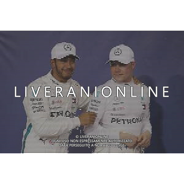 (L to R): Lewis Hamilton (GBR) Mercedes AMG F1 celebrates his pole position in qualifying parc ferme with second placed team mate Valtteri Bottas (FIN) Mercedes AMG F1. 24.11.2018. Formula 1 World Championship, Rd 21, Abu Dhabi Grand Prix, Yas Marina Circuit, Abu Dhabi, Qualifying Day. AG ALDO LIVERANI SAS-ONLY ITALY