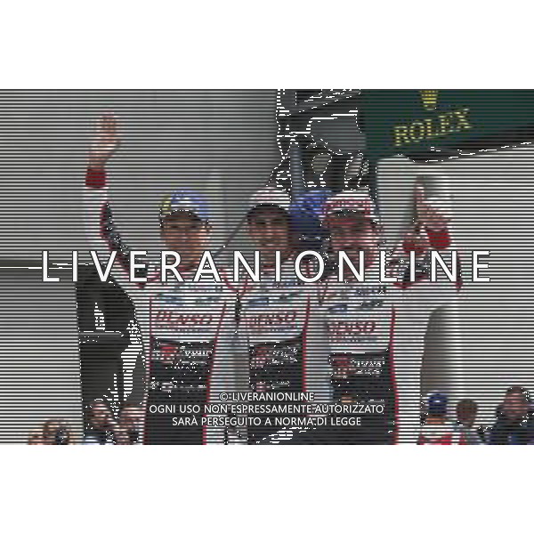 (L to R): race winners Kazuki Nakajima (JPN), Sebastien Buemi (SUI), and Fernando Alonso (ESP) #08 Toyota Gazoo Racing Toyota TS050 Hybrid, celebrate in parc ferme. 16.06.2019. FIA World Endurance Championship, Le Mans 24 Hours, Race, Le Mans, France. Sunday.
