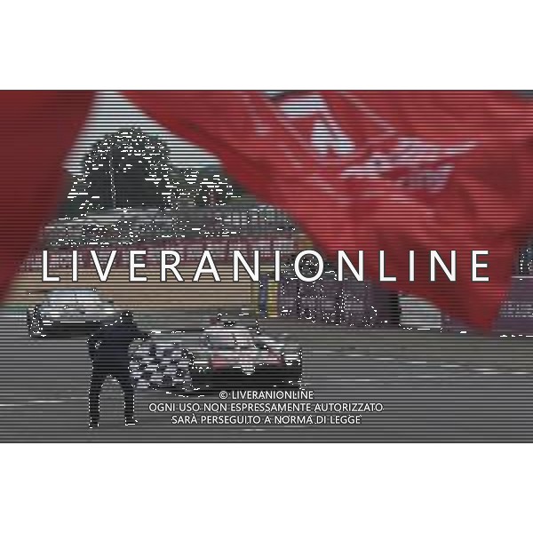 Race winners Sebastien Buemi (SUI) / Kazuki Nakajima (JPN) / Fernando Alonso (ESP) #08 Toyota Gazoo Racing Toyota TS050 Hybrid take the chequered flag at the end of the race. 16.06.2019. FIA World Endurance Championship, Le Mans 24 Hours, Race, Le Mans, France. Sunday.