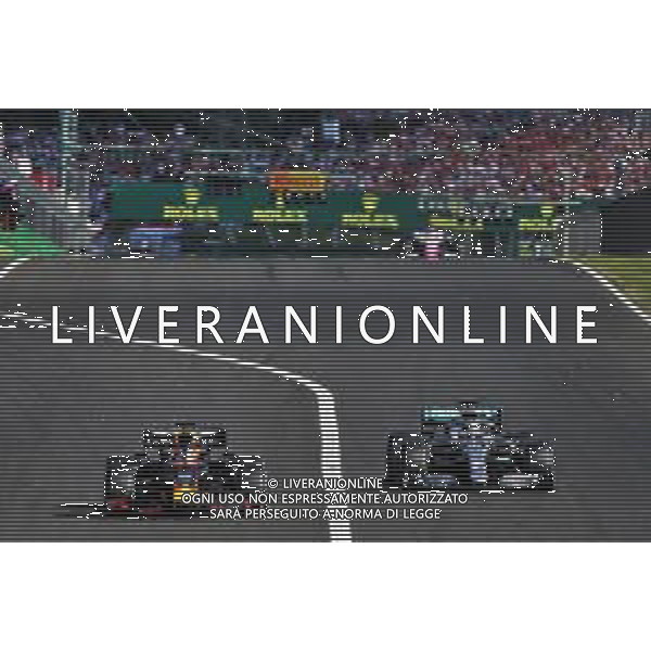 Max Verstappen (NLD) Red Bull Racing RB15 and Lewis Hamilton (GBR) Mercedes AMG F1 W10 battle for the lead of the race. 04.08.2019. Formula 1 World Championship, Rd 12, Hungarian Grand Prix, Budapest, Hungary, Race Day. AG ALDO LIVERANI SAS-ONLY ITALY