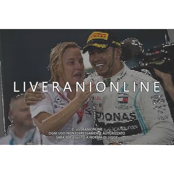 Race winner Lewis Hamilton (GBR) Mercedes AMG F1 celebrates on the podium with Britta Seeger, Member of the Board of Management for Mercedes-Benz Cars Marketing and Sales. 01.12.2019. Formula 1 World Championship, Rd 21, Abu Dhabi Grand Prix, Yas Marina Circuit, Abu Dhabi, Race Day. AG ALDO LIVERANI SAS-ONLY ITALY