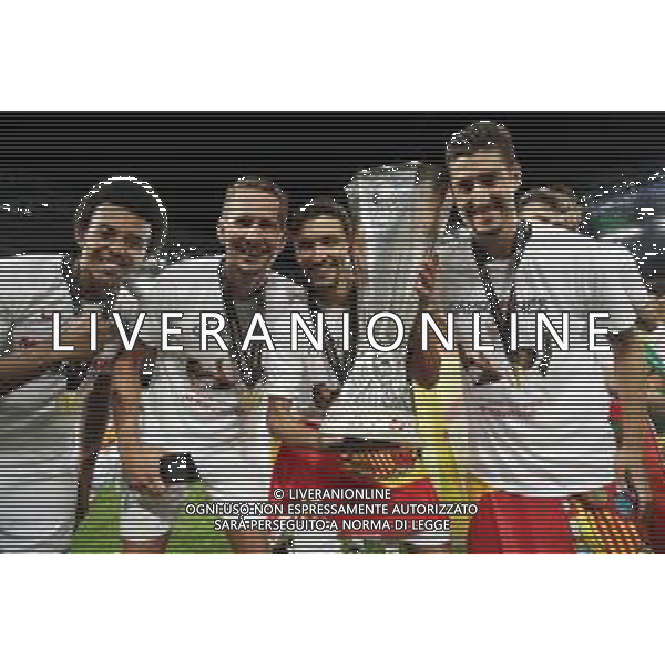 COLOGNE, GERMANY - AUGUST 21: Jules Kounde, Luuk de Jong, Jesus Navas, and Sergio Escudero of Sevilla celebrate with the UEFA Europa League Trophy following their team\'s victory in the UEFA Europa League Final between Seville and FC Internazionale at RheinEnergieStadion on August 21, 2020 in Cologne, Germany. (Photo by Alexander Hassenstein - UEFA/UEFA via Getty Images) AG ALDO LIVERANI SAS