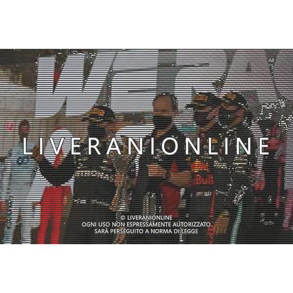 The podium (L to R): Valtteri Bottas (FIN) Mercedes AMG F1, second; Paul Monaghan (GBR) Red Bull Racing Chief Engineer; Max Verstappen (NLD) Red Bull Racing, race winner; Lewis Hamilton (GBR) Mercedes AMG F1, third. 13.12.2020. Formula 1 World Championship, Rd 17, Abu Dhabi Grand Prix, Yas Marina Circuit, Abu Dhabi, Race Day. - www.xpbimages.com, EMail: requests@xpbimages.com © Copyright: Moy / XPB Images/AGENZIA ALDO LIVERANI SAS - ITALY ONLY EDITORIAL USE ONLY