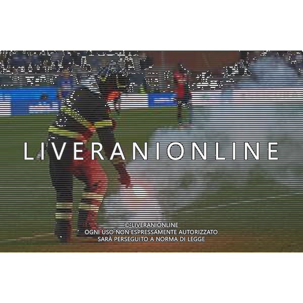 Danilo Vigo/LMedia - UC Sampdoria vs Genoa CFC - italian soccer Serie A match 2021/2022 April 30 2022 - Luigi Ferraris stadium Genova, Italy UC Sampdoria vs Genoa CFC Photo showing: Firefighter recovers smoke bomb in the field - i pompieri cercano di spegnere i fumogeni buttati in campo dai tifosi @Danilo Vigo/LiveMedia /AGENZIA ALDO LIVERANI SAS