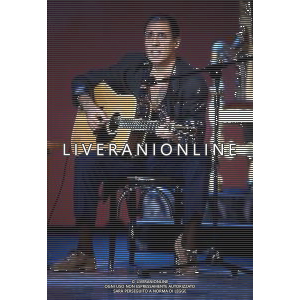 DIAP-RETROSPETTIVA ADRIANO CELENTANO ATTORE CANTANTE  NELLA FOTO ADRIANO CELENTANO NELL\'ANNO 1991 NELLA TRASMISSIONE TELEVISIVA “NOTTE ROCK“  AG ALDO LIVERANI SAS  