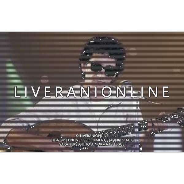 DIAP-RETROSPETTIIVA EUGENIO BENNATO CANTANTE NELLA FOTO EUGENIO BENNATO A RIVA DEL GARDA NELL\'ANNO 1987 AG ALDO LIVERANI SAS