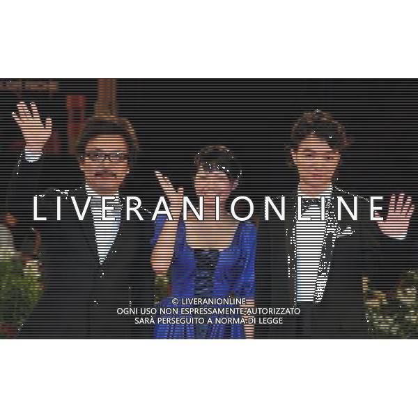 (110906) -- VENICE, Sept. 6, 2011 () -- Japanese director Sion Sono (L), actors Fumi Nikaidopose (C) and Shota Sometani pose on the red carpet for the premiere of the film \'Himizu\' at the 68th Venice Film Festival in Venice, Italy, Sept. 6, 2011. (/Wang Qingqin)