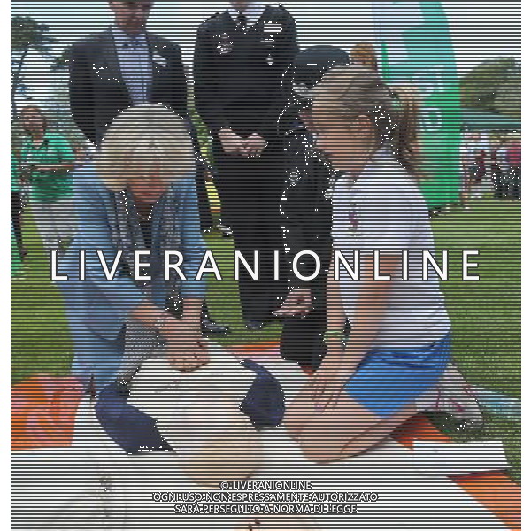 GUERNSEY, GUERNSEY - JULY 19: Camilla, Duchess of Cornwall learns how to perform resuscitation with the St John\'s Ambulance as she takes part in a Youth Showcase during a visit to Saumarez Park on July 19, 2012 in St Peter\'s Port, United Kingdom. The Prince of Wales and the Duchess of Cornwall are in Jersey as part of a Diamond Jubilee visit to the Channel Islands taking in Jersey, Guernsey and Sark ©photoshot/AGENZIA ALDO LIVERANI SAS - ITALY ONLY - REALI INGLESI: Il principe Carlo d\'inghilterra e la moglie Camilla in visita alle Isole Normanne. 