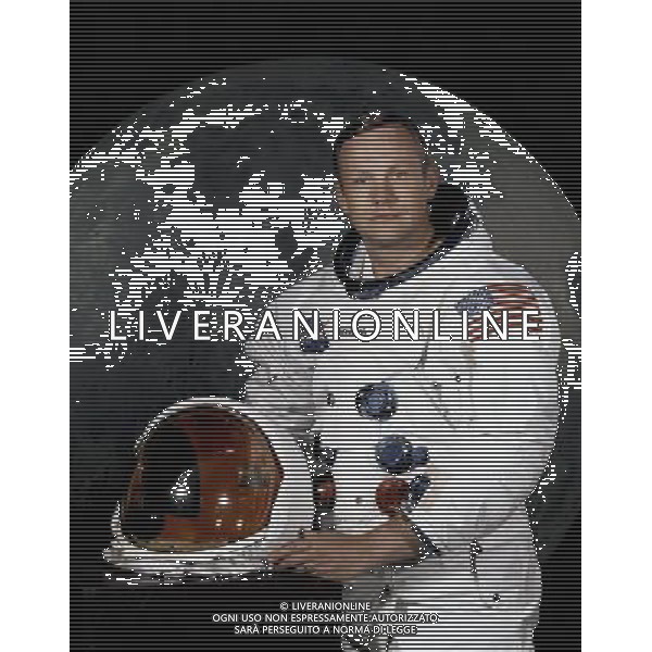 USA Florida -- 1969 -- Portrait of Astronaut Neil A. Armstrong, commander of the Apollo 11 Lunar Landing mission in his space suit, with his helmet on the table in front of him. Behind him is a large photograph of the lunar surface -- Picture by Lightroom Photos/NASA AG ALDO LIVERANI S A S ONLY ITALY